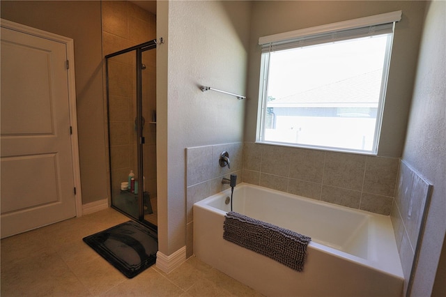 bathroom featuring tile patterned floors, plenty of natural light, and shower with separate bathtub