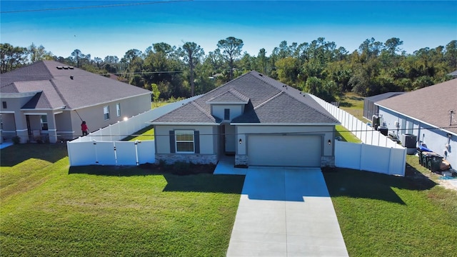 view of front of home featuring a front yard and a garage