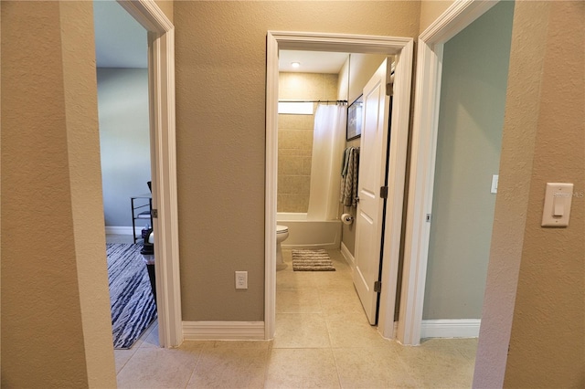 3393 Kacher Rd, North Port, FL 34288 - corridor with tile patterned flooring, a textured wall, and baseboards
