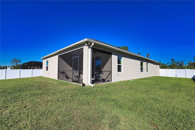 3393 Kacher Rd, North Port, FL 34288 - back of property featuring stucco siding and a sunroom