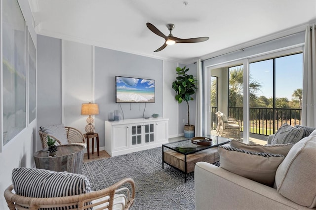 living room featuring ceiling fan and crown molding