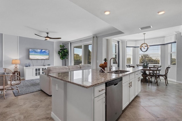 kitchen with white cabinetry, dishwasher, an island with sink, and sink