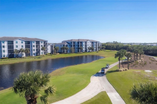 surrounding community featuring a yard and a water view