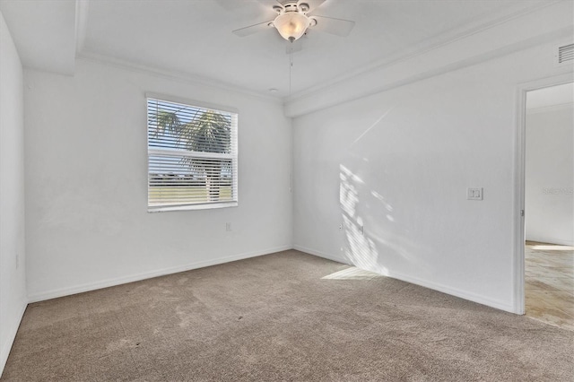 spare room with light colored carpet, ceiling fan, and crown molding