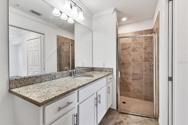 bathroom featuring tile patterned floors, vanity, ornamental molding, and walk in shower