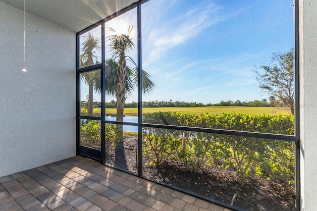 unfurnished sunroom featuring a rural view