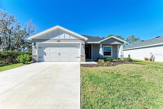 view of front of home with a garage and a front lawn