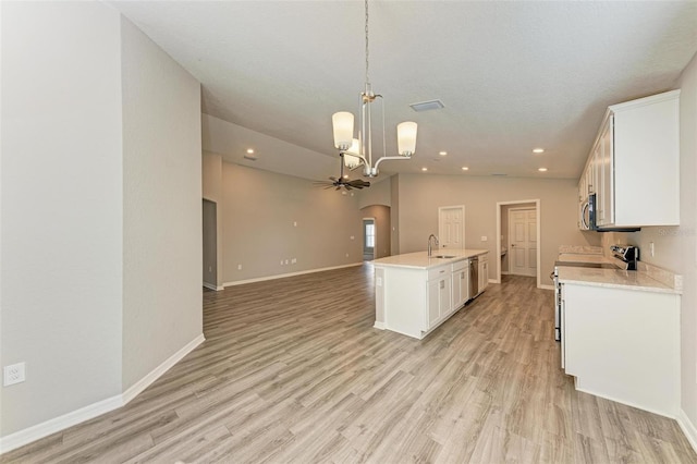 kitchen with white cabinets, light hardwood / wood-style floors, a kitchen island with sink, and lofted ceiling