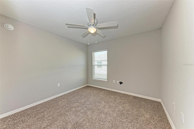 unfurnished room with carpet, ceiling fan, and a textured ceiling