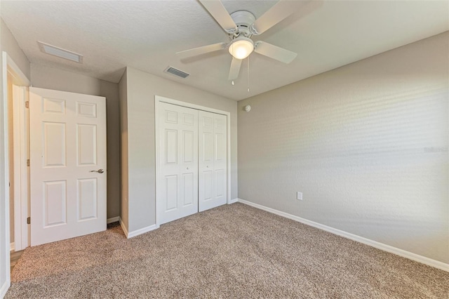 unfurnished bedroom with ceiling fan, carpet floors, and a closet