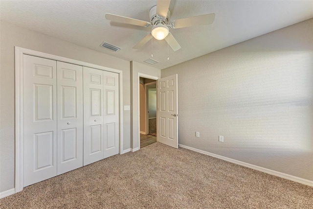 unfurnished bedroom featuring carpet flooring, ceiling fan, and a closet