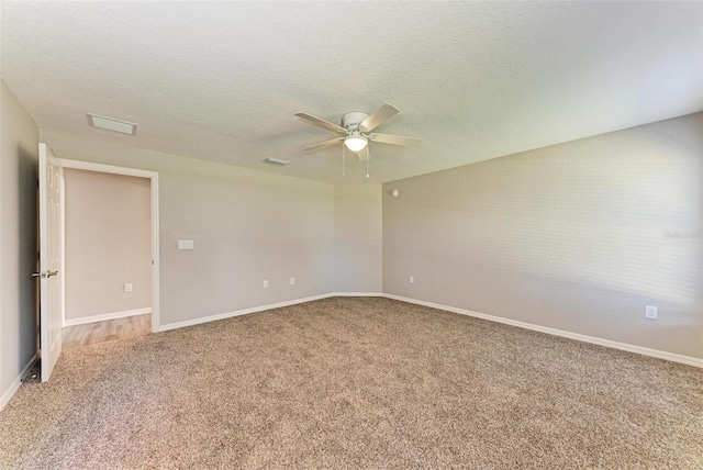 unfurnished room with carpet flooring, ceiling fan, and a textured ceiling