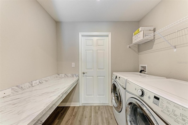 laundry area featuring separate washer and dryer and light wood-type flooring