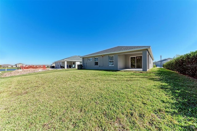 rear view of house featuring a yard