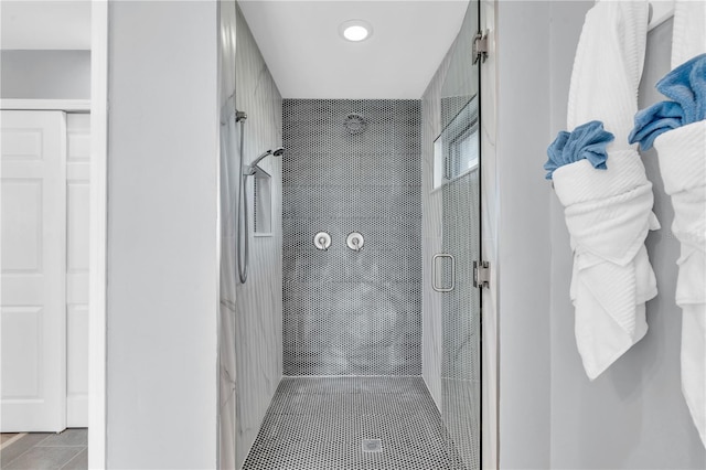 bathroom featuring tile patterned floors and a shower with shower door