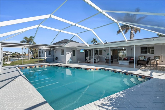 view of swimming pool featuring a lanai, ceiling fan, and a patio