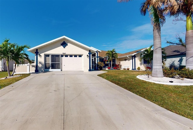 ranch-style home featuring a garage and a front yard