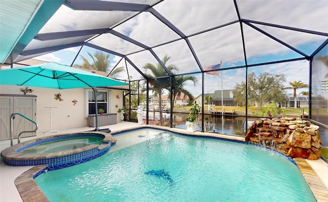 view of pool featuring an in ground hot tub, a water view, and glass enclosure