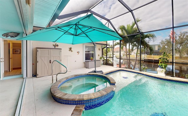 view of pool with glass enclosure, an in ground hot tub, a water view, and a patio