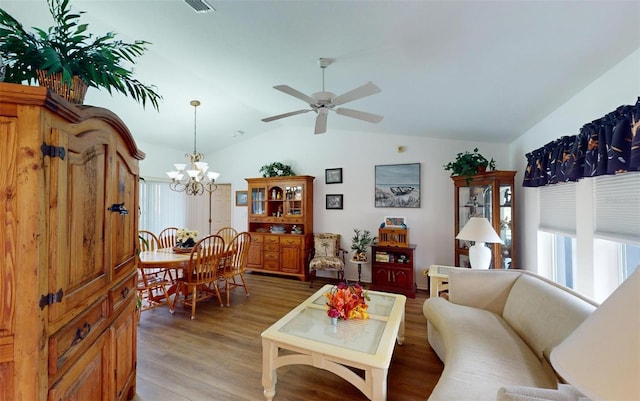 living room with hardwood / wood-style floors, ceiling fan with notable chandelier, and lofted ceiling