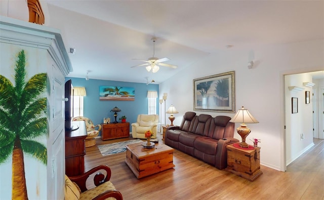 living room with ceiling fan, a healthy amount of sunlight, lofted ceiling, and light wood-type flooring