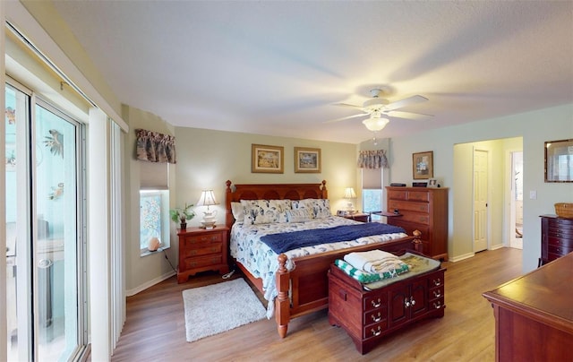 bedroom with light hardwood / wood-style flooring and ceiling fan