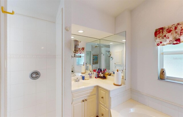 bathroom featuring vanity and tiled shower