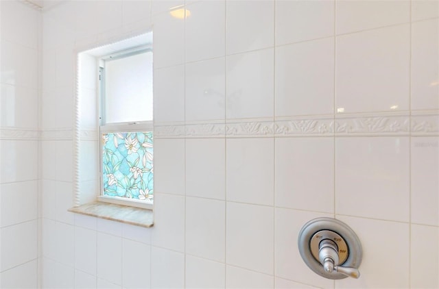 bathroom featuring a shower and tile walls