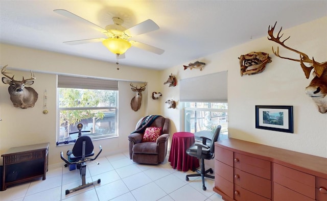 tiled home office featuring ceiling fan