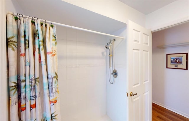 bathroom featuring hardwood / wood-style floors and walk in shower