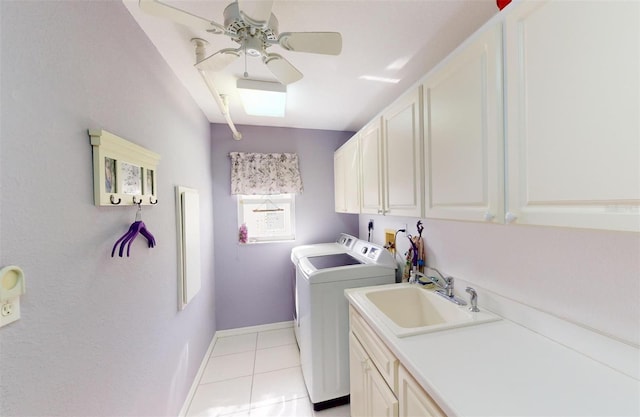 laundry area with cabinets, sink, ceiling fan, light tile patterned flooring, and washing machine and clothes dryer