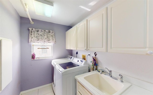 washroom featuring cabinets, light tile patterned floors, sink, and washing machine and clothes dryer