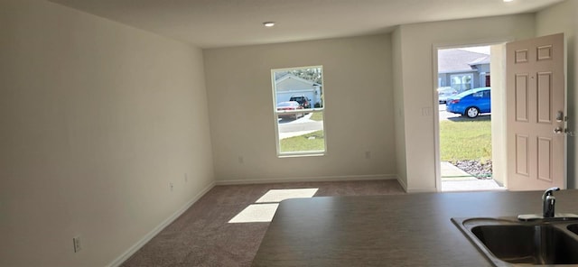 entryway with dark colored carpet and sink