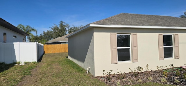 view of side of property with a yard