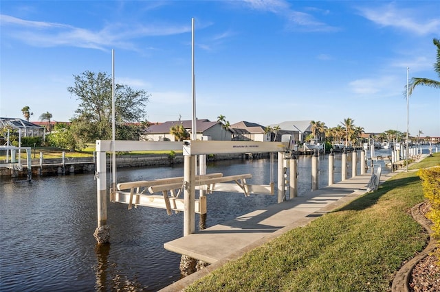 dock area with a water view and a yard