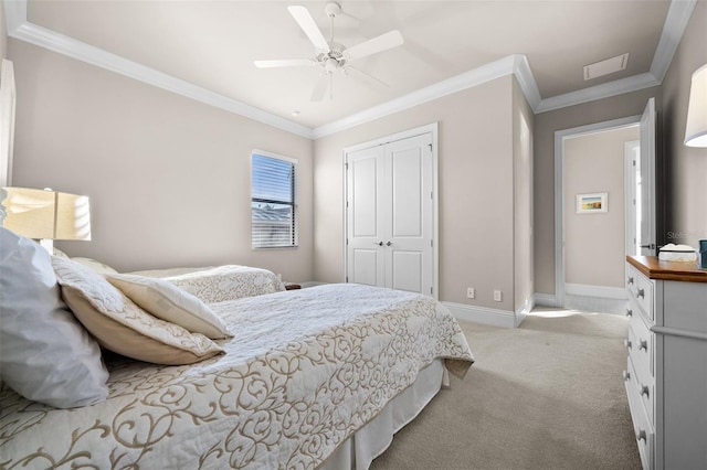 carpeted bedroom with a closet, ceiling fan, and crown molding