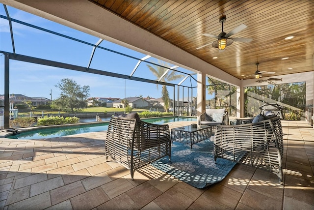 view of patio / terrace with a lanai, outdoor lounge area, and ceiling fan