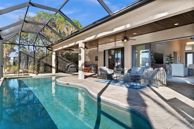 view of pool with glass enclosure, ceiling fan, and a patio