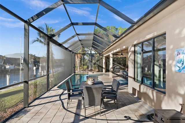 sunroom featuring vaulted ceiling, a water view, and a swimming pool