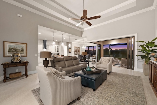 tiled living room featuring a towering ceiling, ceiling fan, and ornamental molding