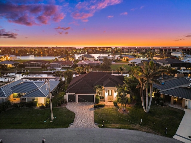 aerial view at dusk with a water view