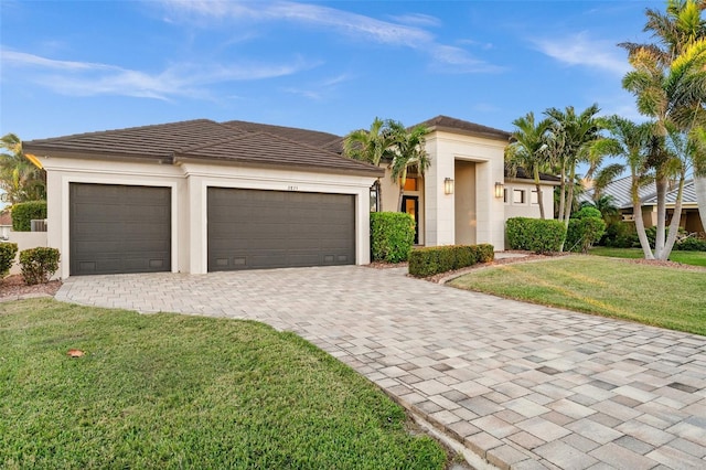 view of front of house featuring a garage and a front lawn