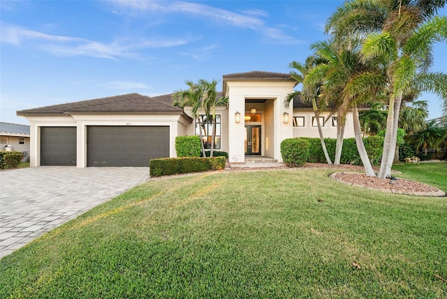 view of front of home featuring a front yard and a garage