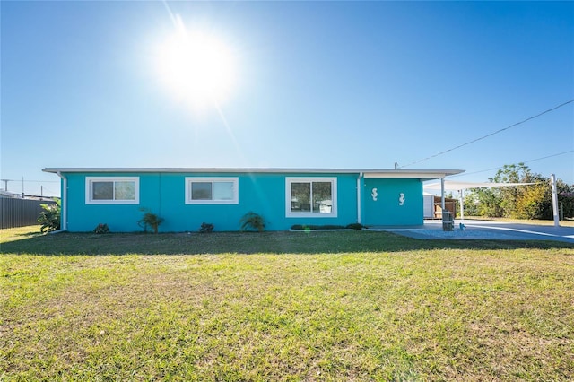 ranch-style house with a carport and a front yard