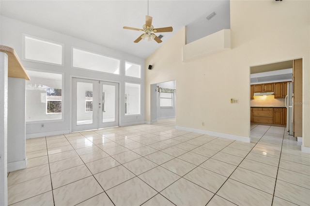 unfurnished living room with french doors, high vaulted ceiling, ceiling fan, and light tile patterned flooring