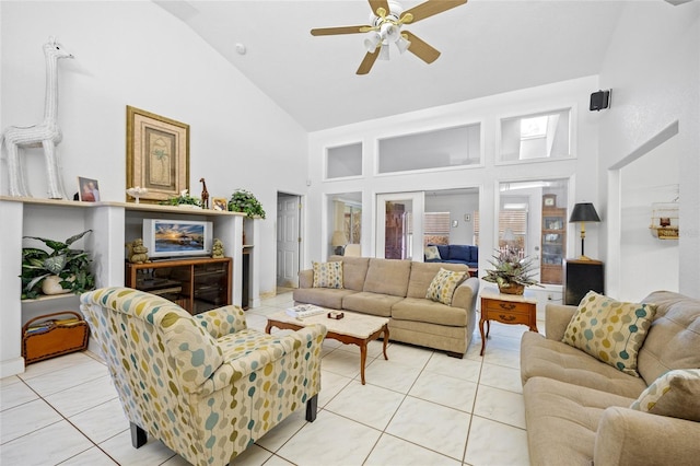 tiled living room with ceiling fan and high vaulted ceiling