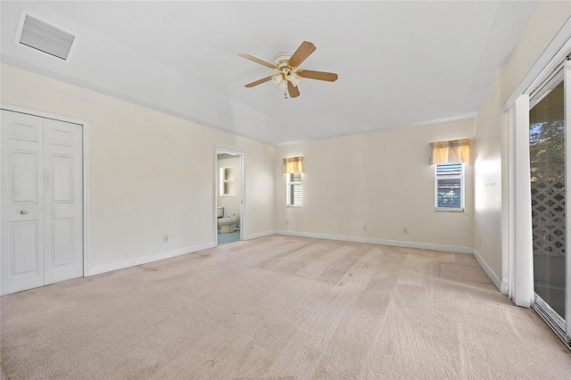 spare room featuring ceiling fan and light colored carpet