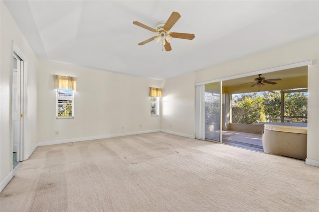 spare room with plenty of natural light, ceiling fan, and light colored carpet