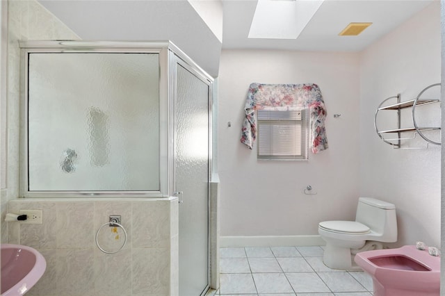 bathroom featuring a skylight, an enclosed shower, a bidet, tile patterned flooring, and toilet