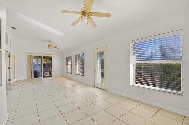 interior space featuring ceiling fan and vaulted ceiling with skylight